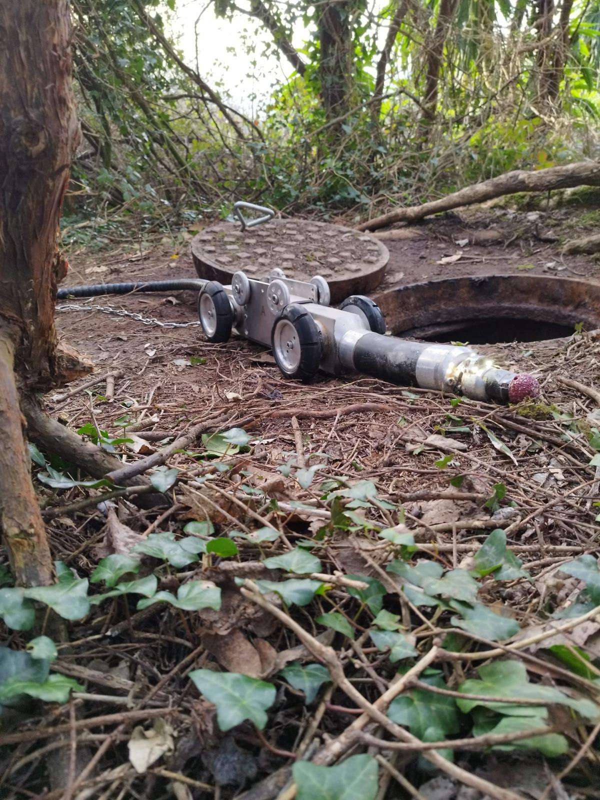 Robotic cutter entering sewer system for repair purposes